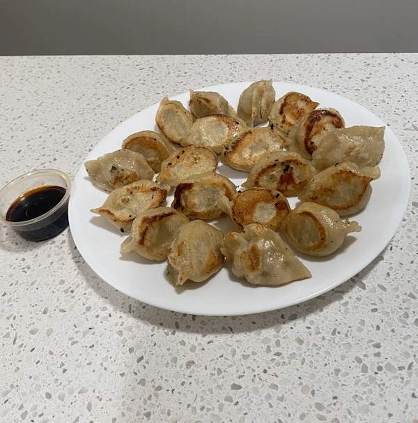 Fried Sooke Dumplings on a plate with sauce